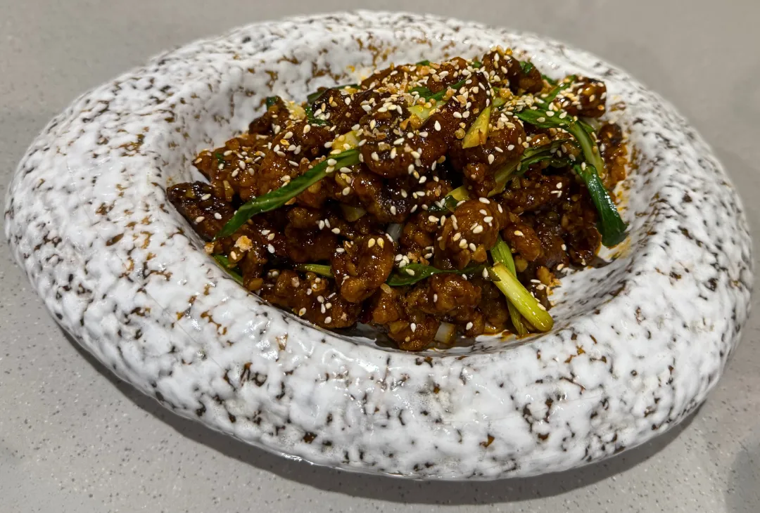 Konjee crispy lamb with Hoisin sauce and sesame
