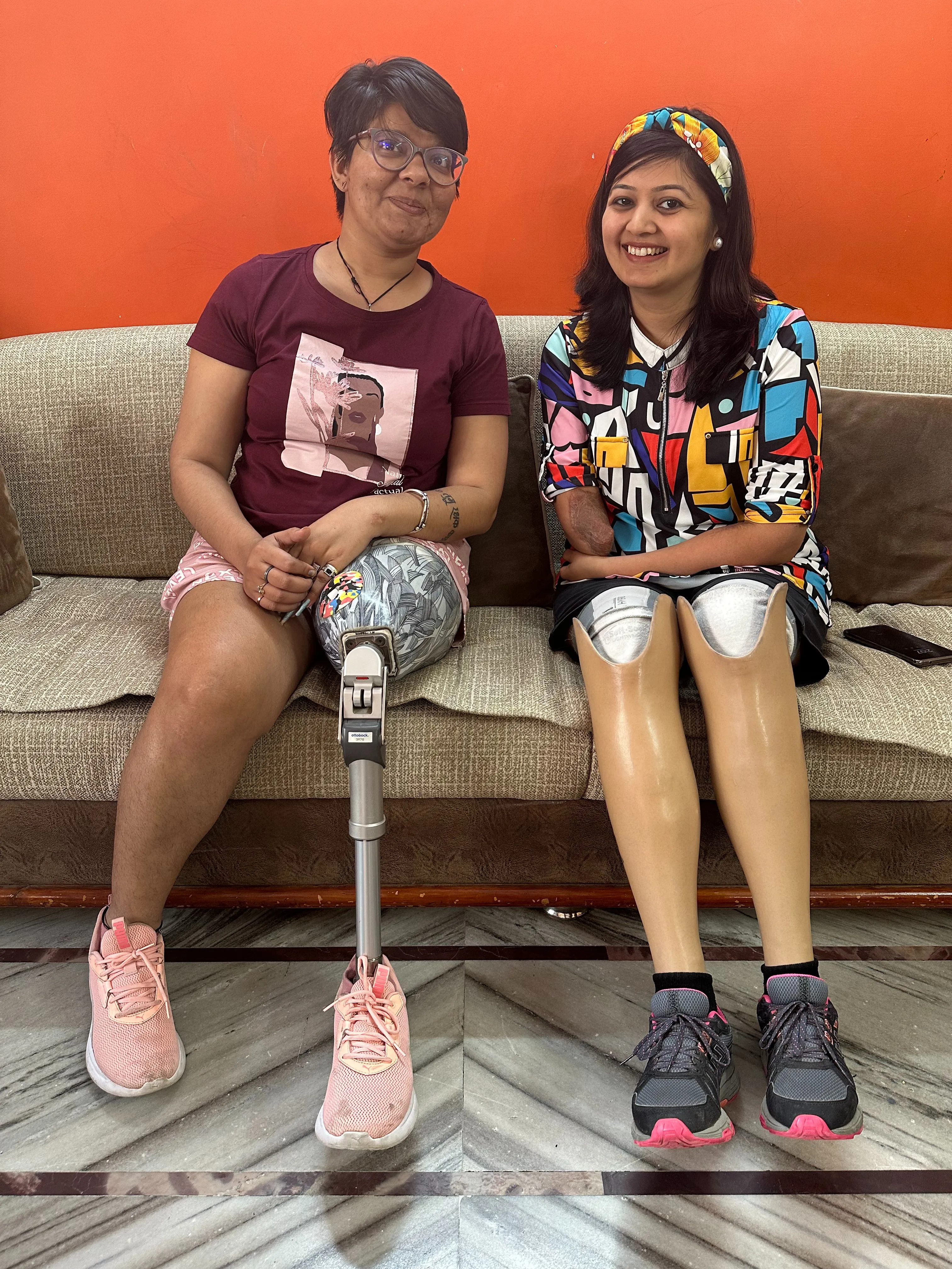 Neha Bhat with an amputee who is living full lives with prosthetic legs