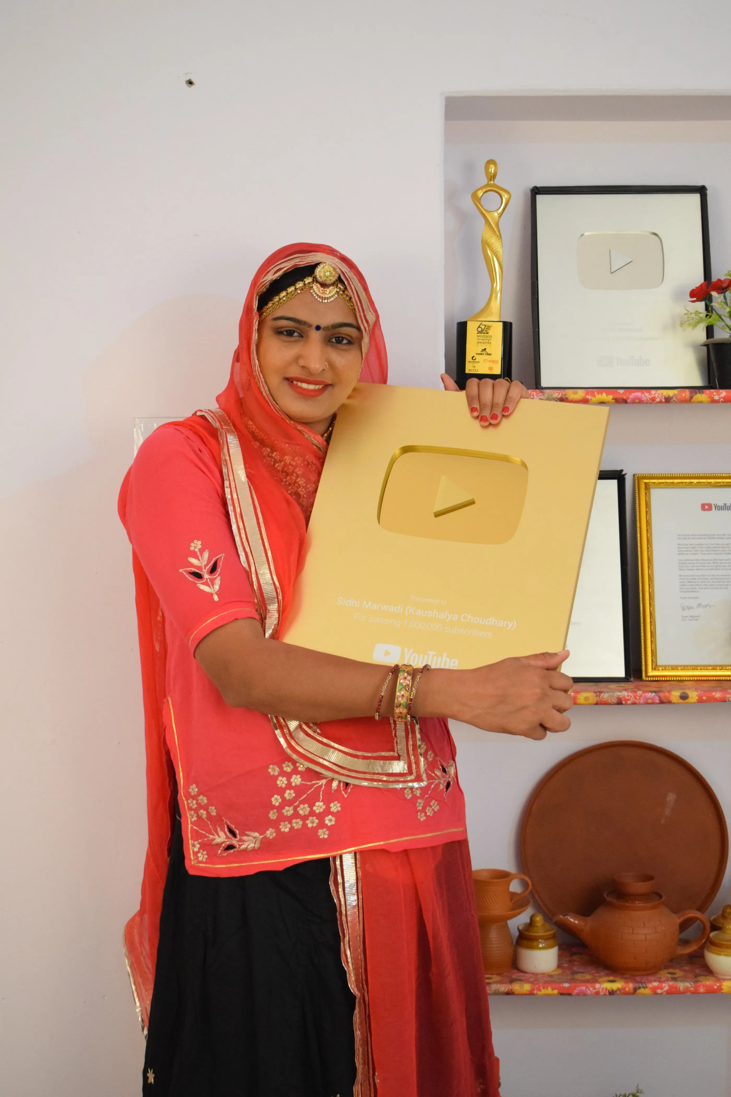 Kaushalya with her YouTube Gold Play button