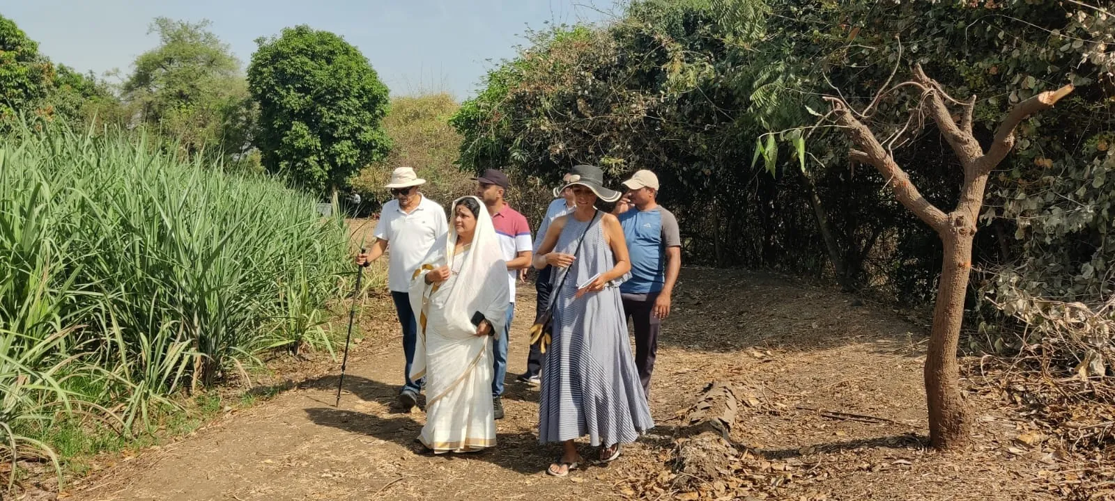 Kavita is with a foreign dignitary at the farm