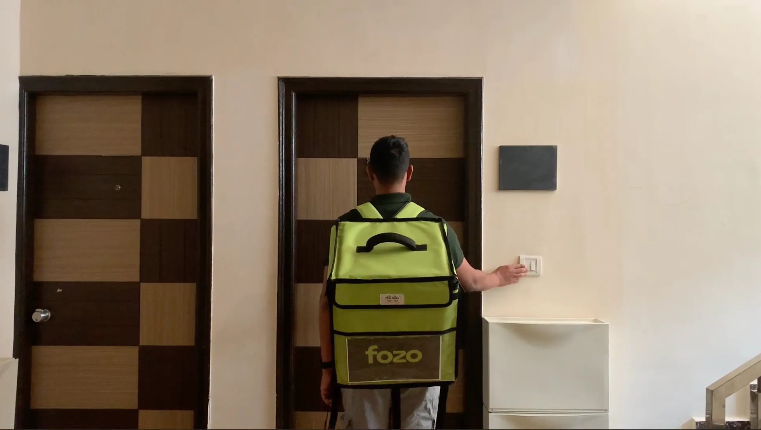 A delivery partner of Fozo at the doorstep of a customer