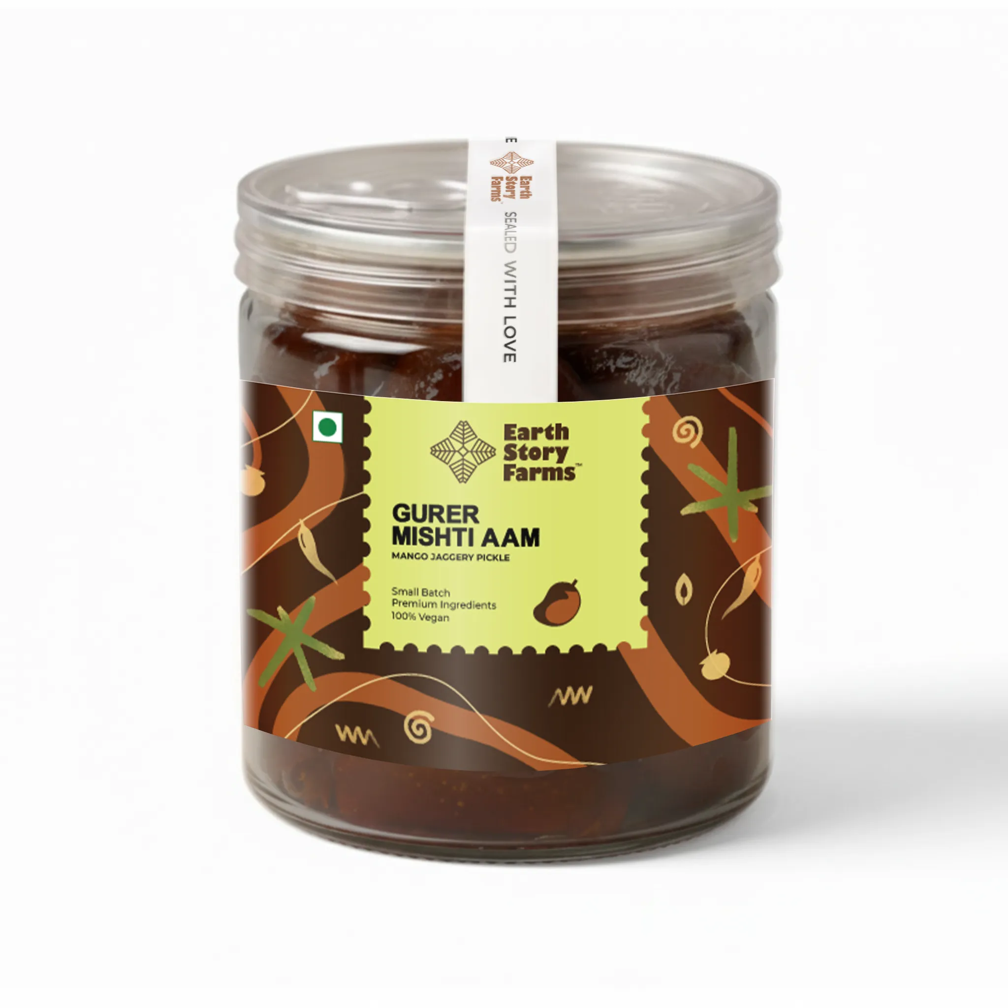 A glass jar of Gurer Mishti Aam (Mango Jaggery Pickle) from Earth Story Farms
