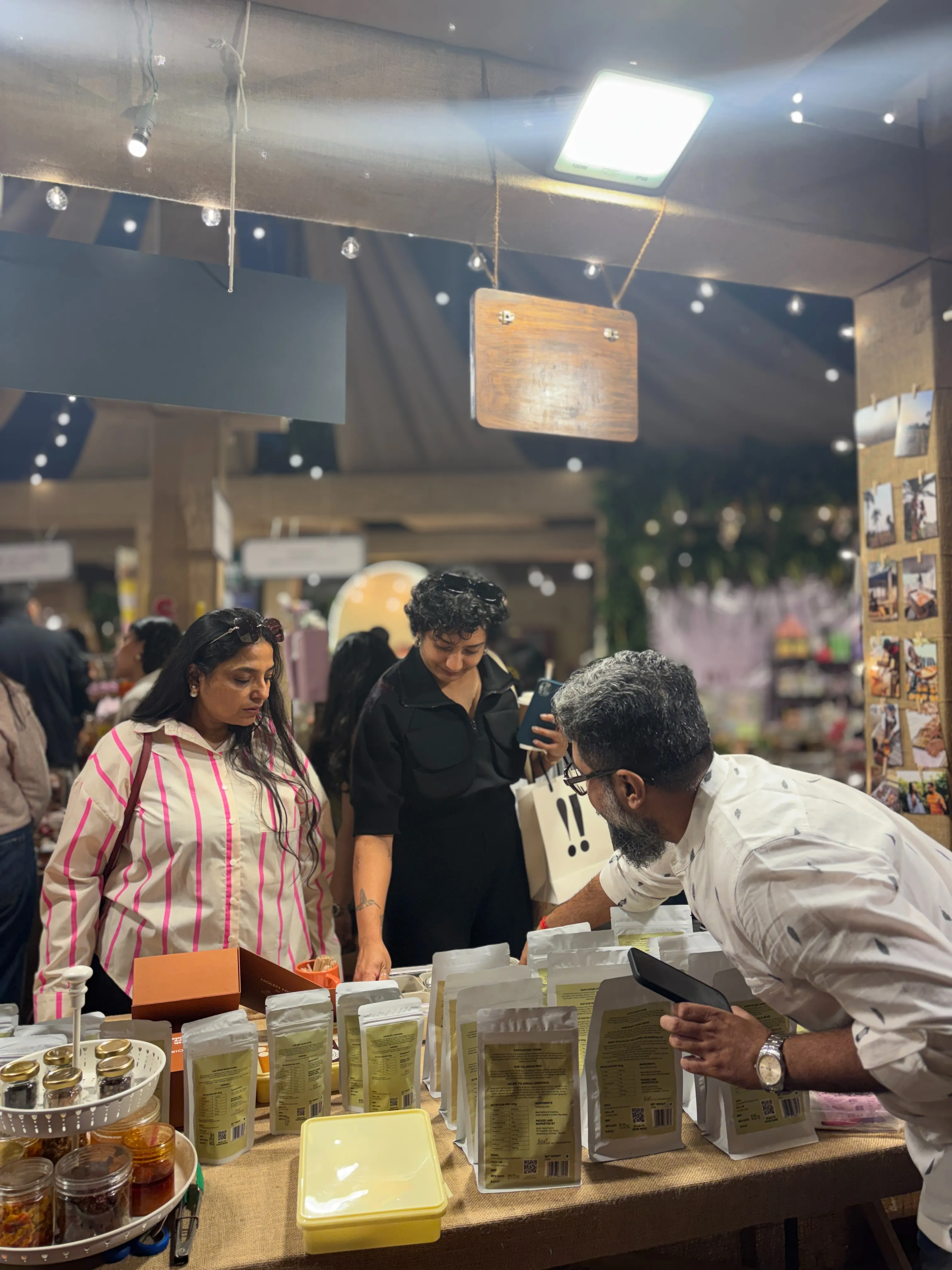 Founders Abhishek and Senjuti engaging with customers at an Earth Story Farms stall, showcasing their range of native Indian culinary gems