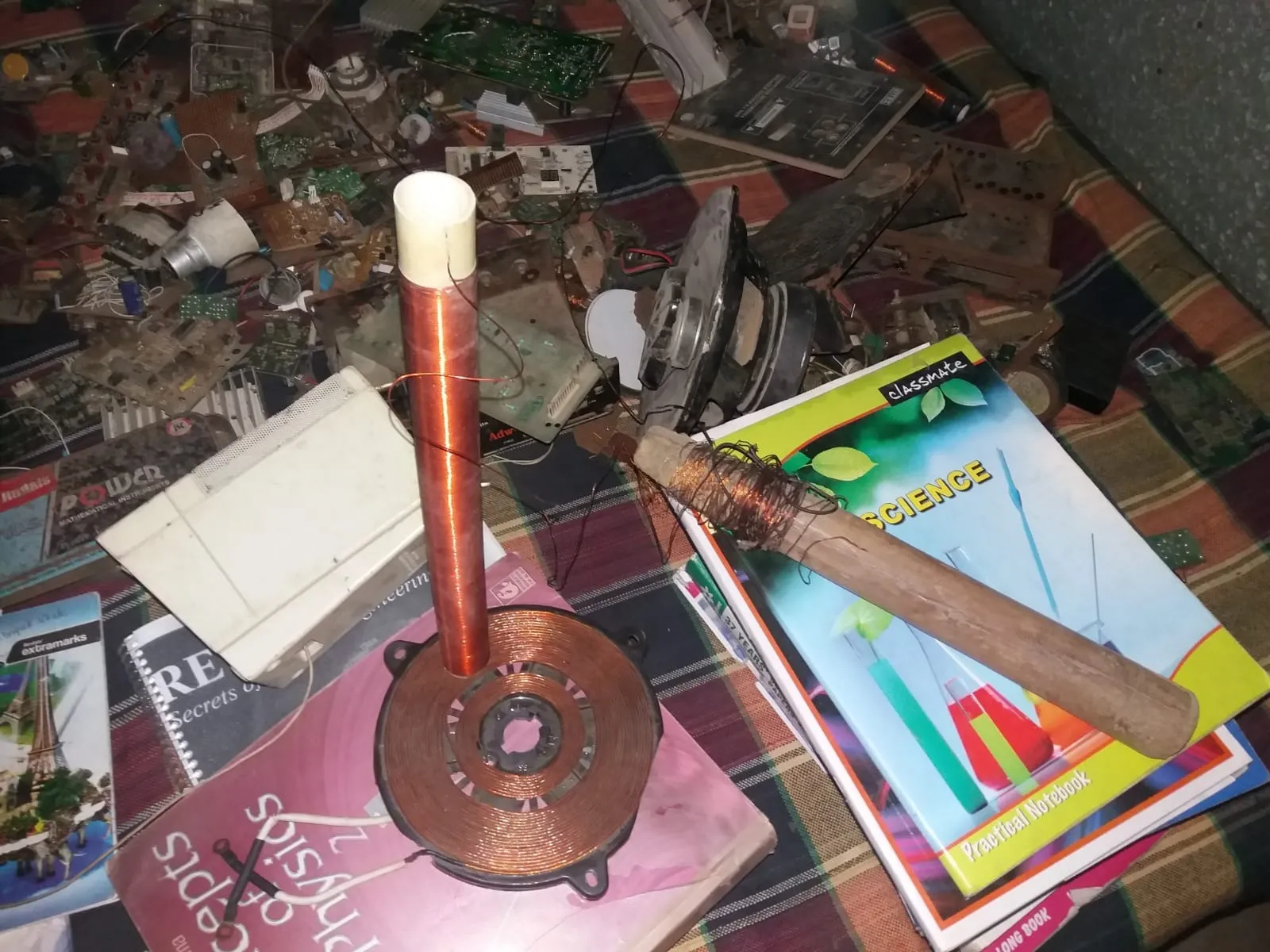 A glimpse of an early electronics experiment setup made using copper coils, wires, and scrap circuit parts
