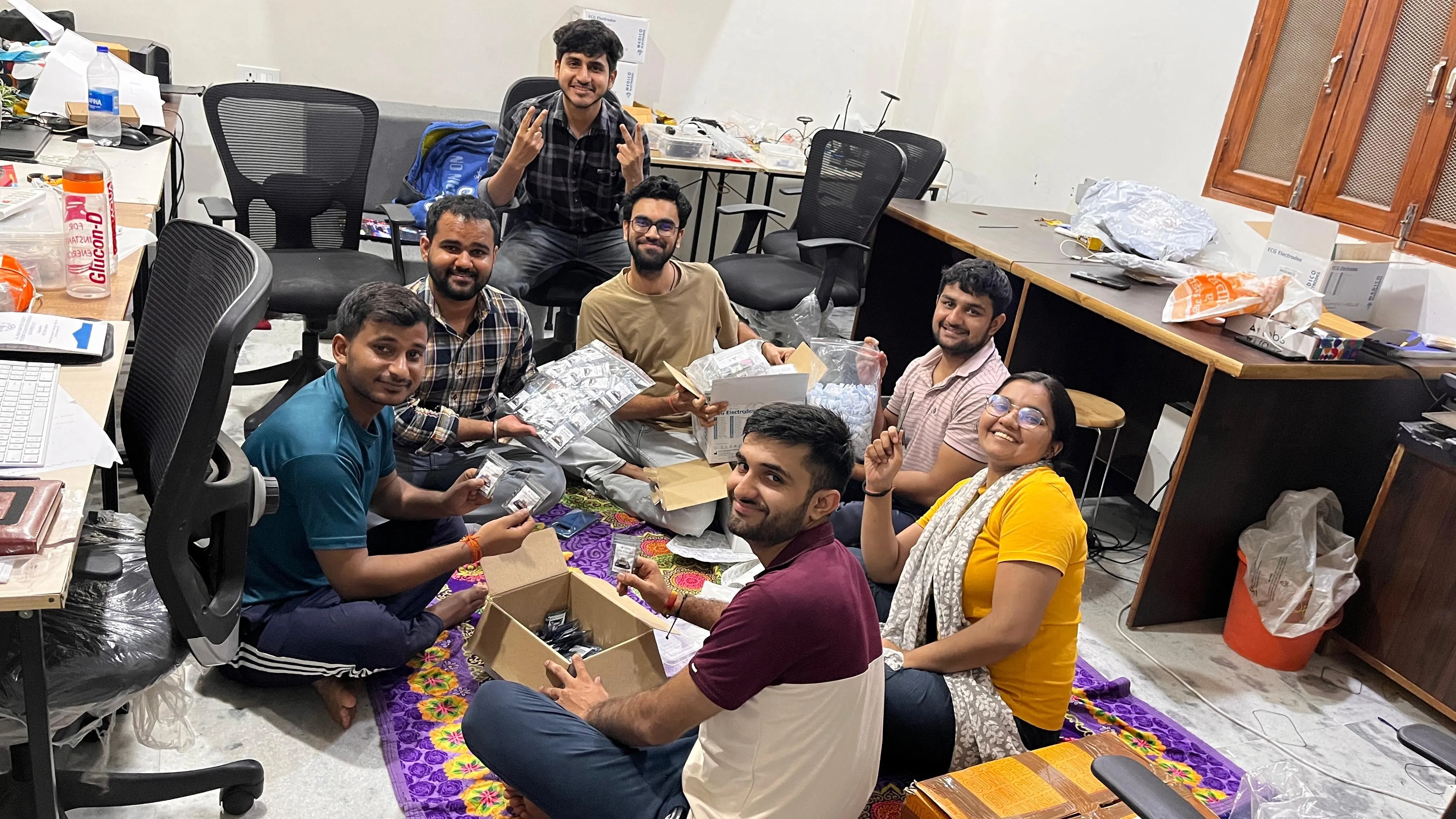Team Upside Down Labs assembling and packing components together during a busy workday at the lab
