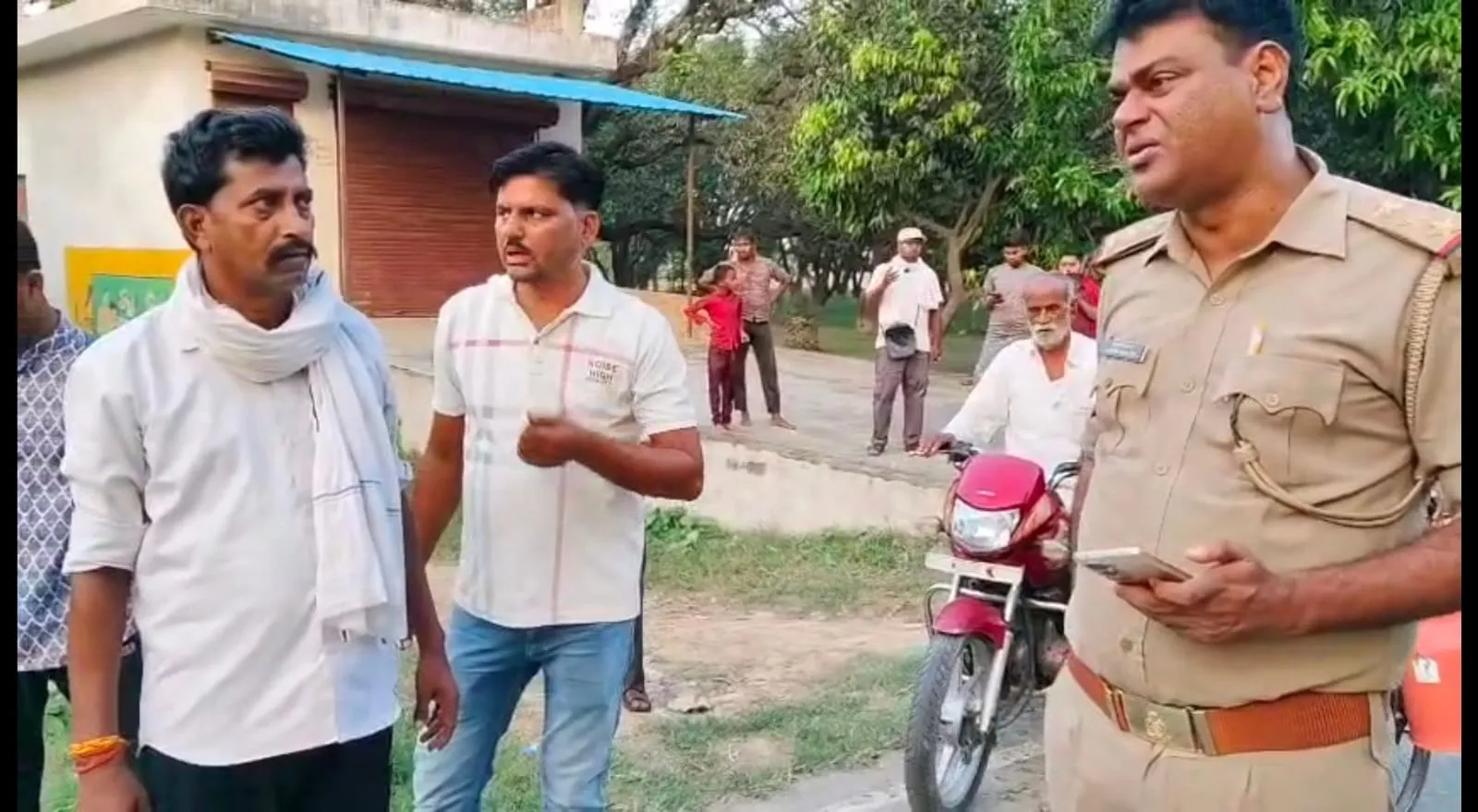 पुलिस की गाडी से दुर्घटना में तीन लोगों के घायल होने पर सिंपाही से रोष जताते लोग
