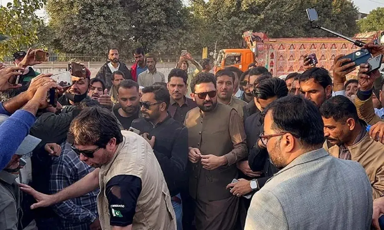 KP Chief Minister Sohail Afridi is accompanied by PTI supporters as they gather to visit Imran Khan outside Adiala Jail in Rawalpindi