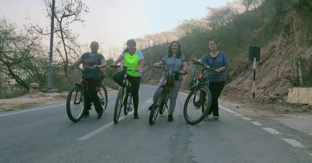 women group cycling on an empty road