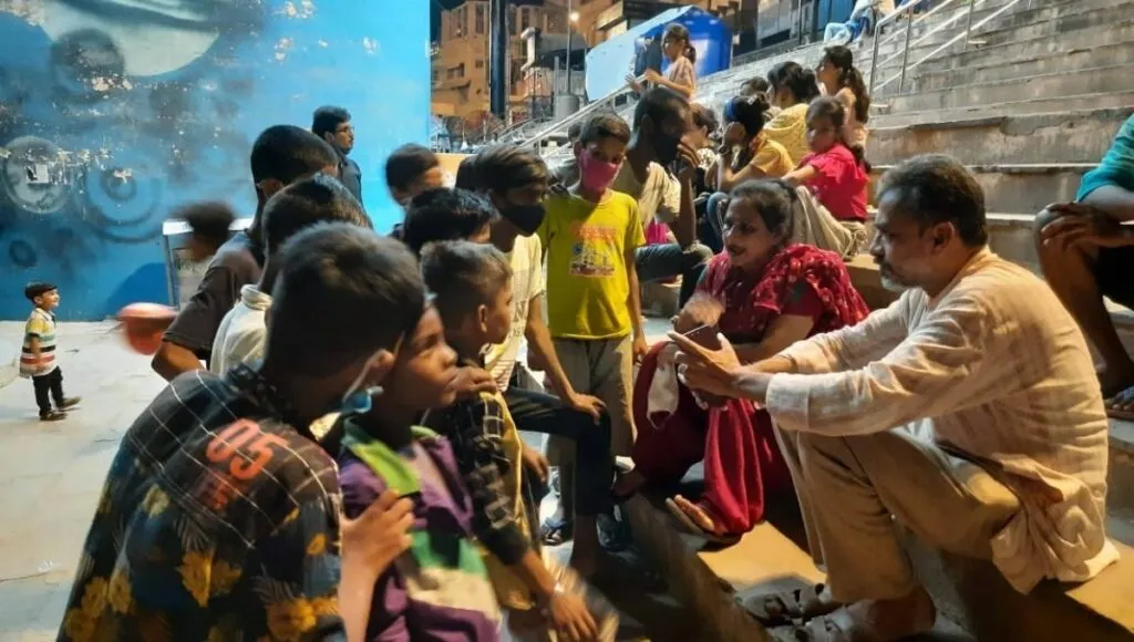 Chandra Mishra with beggars in Varanasi