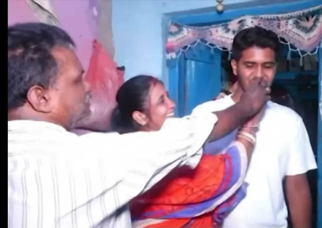 Suraj celebrating with parents.<br />
