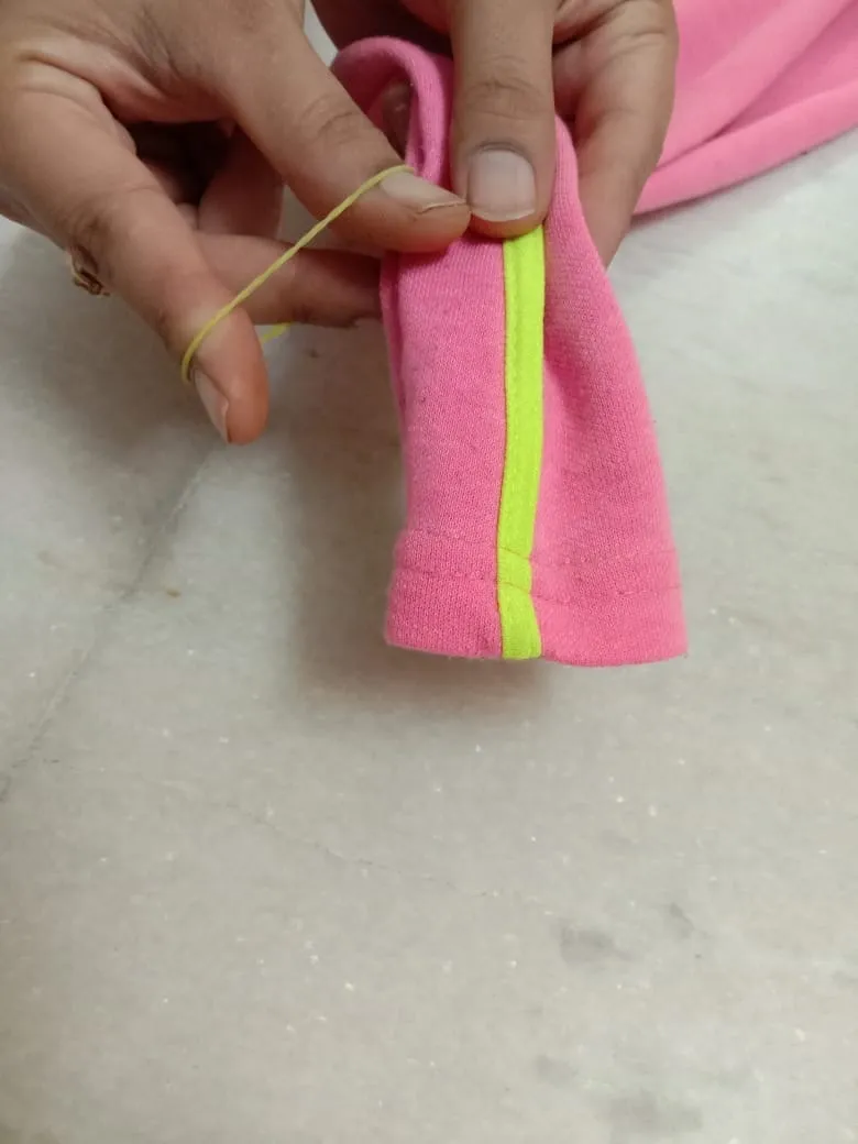 for making planter cover first step is, use rubber bands to tie the bottom of the pant.