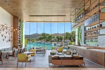 A room with a pool and tables

AI-generated content may be incorrect.