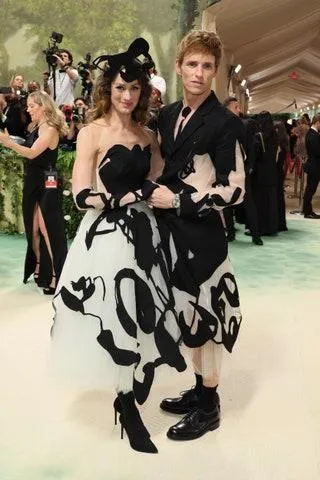 Image may contain Eddie Redmayne Adult Person Clothing Dress Footwear Shoe Costume Formal Wear and Wristwatch