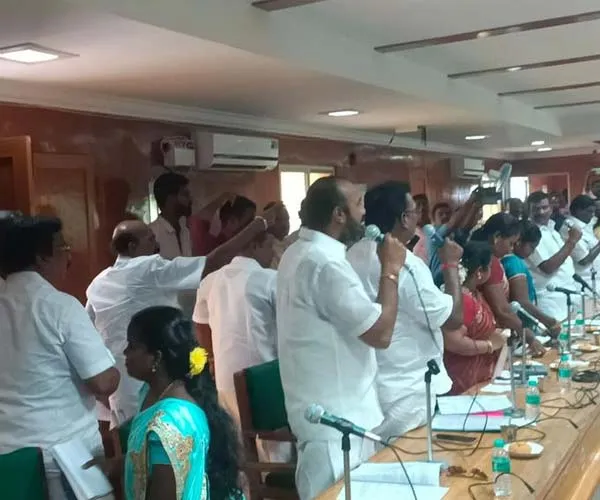 Opposition members struggle at a meeting held in Vriddhachalam