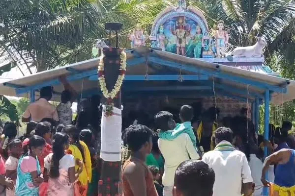 Devotees break coconuts on their heads during temple festivals