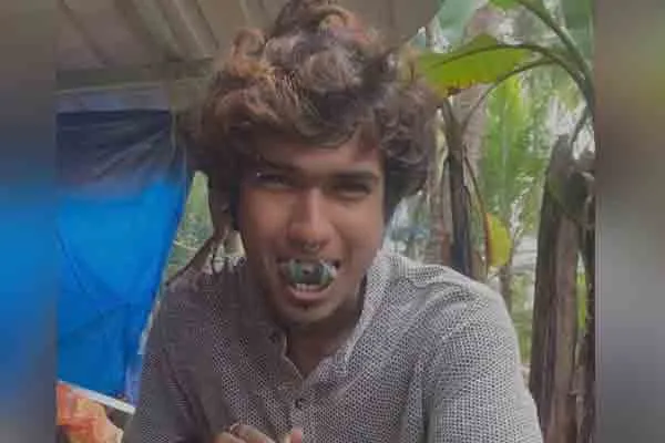 oung man with a split tongue and a tattoo
