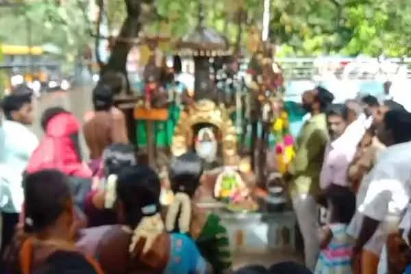 Muslim woman bowing in worship at the Veeramuni Andavar temple.
