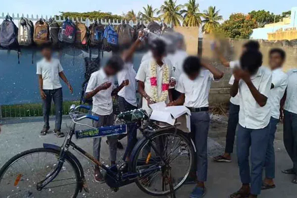 Birthday celebration of students by cutting a cake in middle of road 