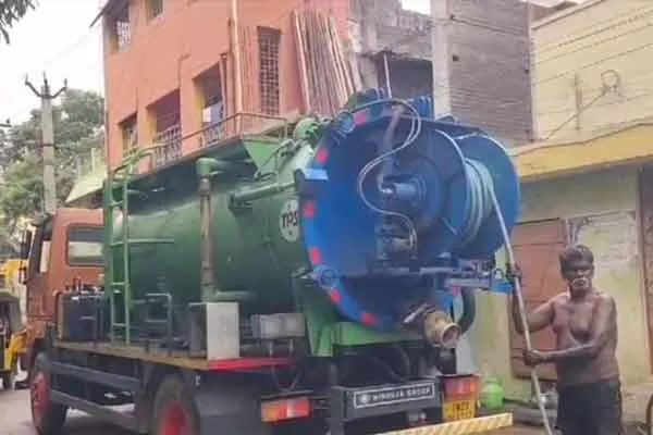 Workers who go down the drain without protection and scoop waste