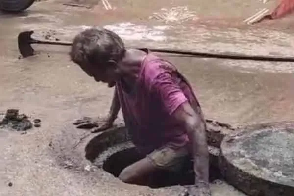 Workers who go down the drain without protection and scoop waste