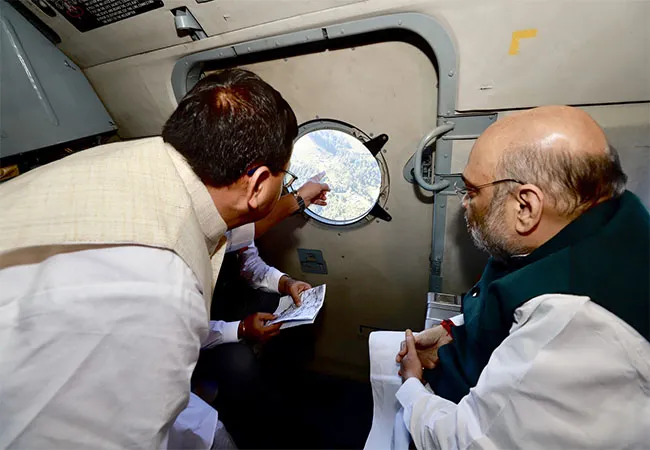Amitsha inspecting flood-affected areas by helicopter