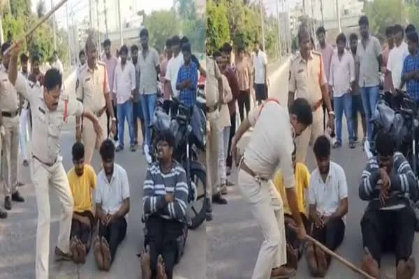 Police beat youths with lathi in the middle of the road in andhra pradesh