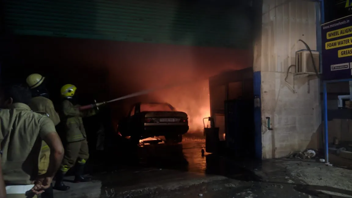 At night in Ambattur, the car service center is fire