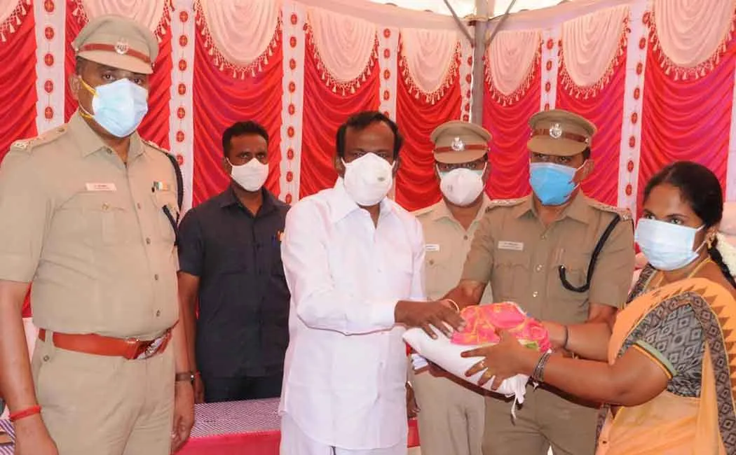 Minister Muthusamy who provided welfare assistance to the police