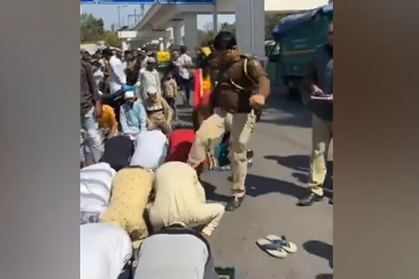 police kicking Muslims engaged in prayer in delhi