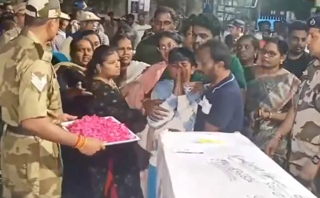 A crying son hugging his father's body at pahalgam incident