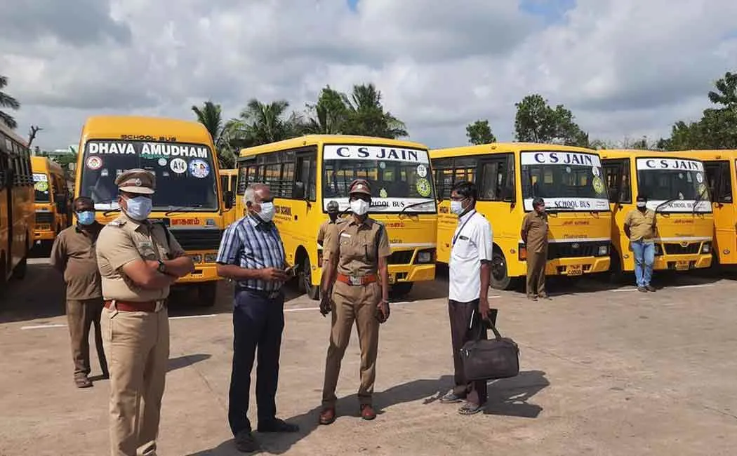 Government officials inspecting school vehicles