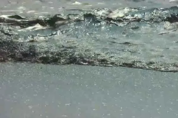 Oil floating in the ocean after a pipeline breaks; 