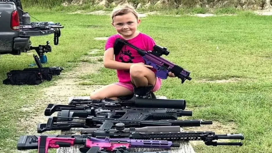 8 yr girl with several guns