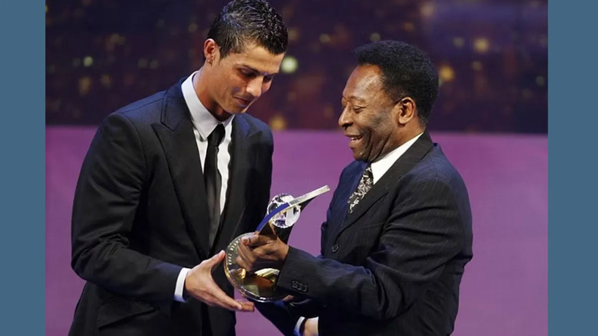 Soccer player Cristiano Ronaldo receives the trophy from former Brazilian soccer star Pele