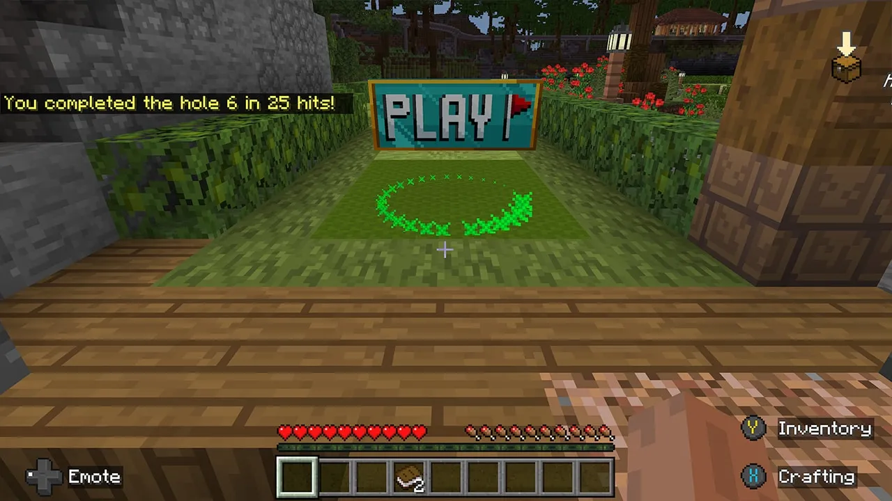 A mini golf green shows a glowing circle and a PLAY sign after completing a hole