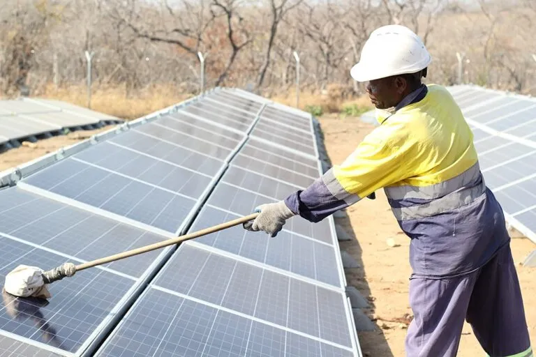 A solar technician cleans a panel. Some jobs may be considered “core green” such as a solar technician, while some others are “indirectly green” such as a construction worker in a green building. Image by Deo photographer via Wikimedia Commons (CC BY-SA 4.0).