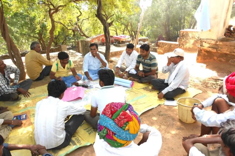 Farmers discuss climate-smart technologies and practices. Green jobs aren't limited to modern offices, looking at data and metrics. Grassroots workers involved in disaster relief or community-based environmental work also qualify as green jobs. Image via Flickr (CC BY-NC-SA 2.0).