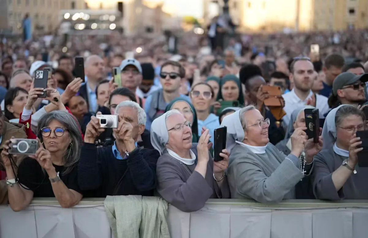People listen to the speech of the newly elected Pope Leo XIV. AP Photo/Francisco Seco