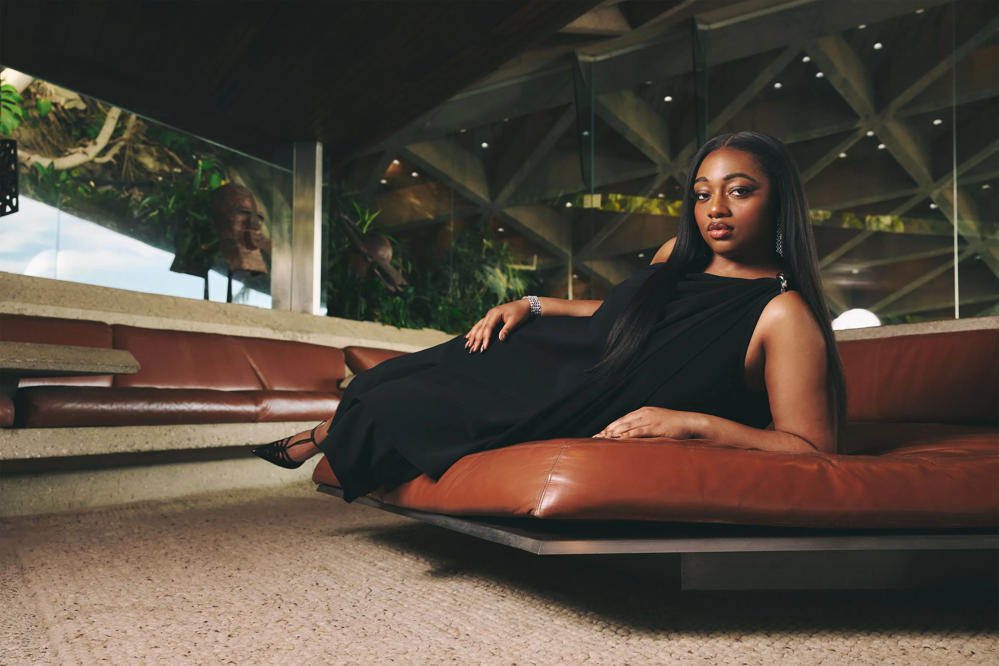 a woman reclines in a black dress