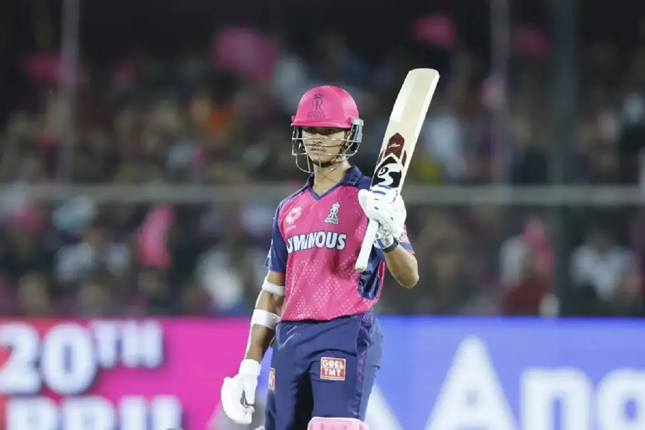 Yashasvi Jaiswal raises his bat after getting to his fifty