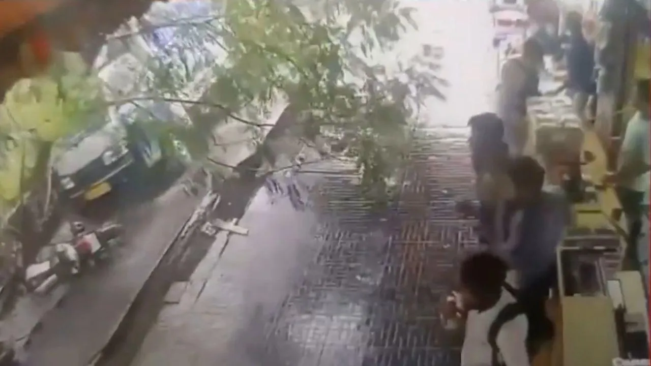 Heavy rain in Mumbai Ground caved in, wall collapsed and many bikes got buried under the debris