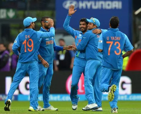 Ravindra Jadeja is mobbed by teammates after dismissing Jos Buttler, England v India, Champions Trophy final, Edgbaston, June 23, 2013