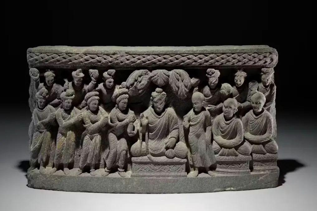 A scene depicting the Buddha in the center with Mahaprajapati to his right, pleading with him to establish a nuns’ order. Pakistan, second to third centuries C.E. © The Trustees of the British Museum, CC BY-NC-SA