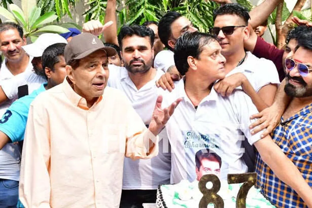 Dharmendra is all smiles as he cuts a cake with fans on his 87th birthday.  See pics: | Filmfare.com