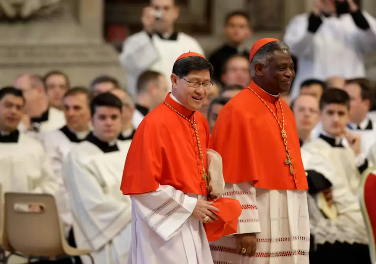 Cardinals Luis Antonio Tagle (left) of the Philippines and Peter Kodwo Appiah Turkson of Nigeria attend a Mass inside St. Peter’s Basilica for the election of the new pope in 2013. Andrew Medichini/AP