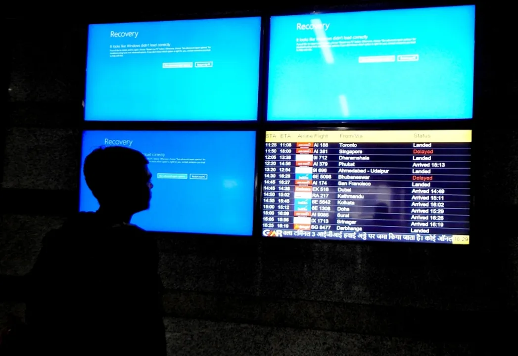 New Delhi: A passenger looks at the displays as there are delays in airline services caused by an ongoing global outage of Microsoft at Terminal 3 of Delhi Airport in New Delhi on Friday, July 19, 2024. (Photo: IANS/Anupam Gautam) 