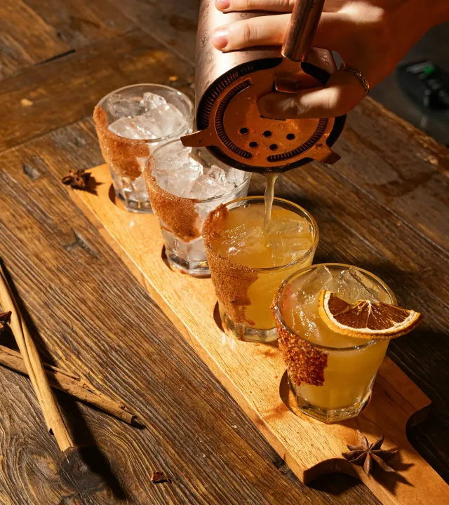 Four drinks being made at the bar counter to show how Indians are leaning towards agave spirits in India with Indian agave spirits being made even though there's confusion about tequila vs agave