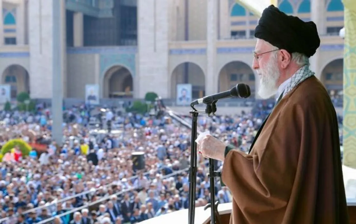 irans khamenei speaks with a rifle beside him and warns Israel