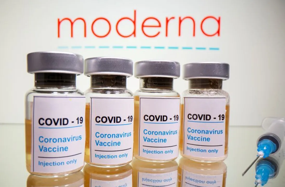  FILE PHOTO: Vials with a sticker reading, "COVID-19 / Coronavirus vaccine / Injection only" and a medical syringe are seen in front of a displayed Moderna logo in this illustration taken October 31, 2020. REUTERS/Dado Ruvic/Illustration//File Photo 