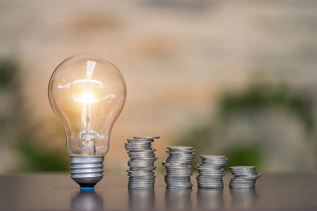  coins and light bulb. concept saving money. 